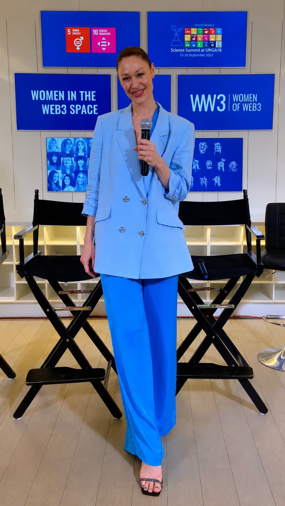 Carley Beck speaking on stage at the UNGA78 Science Summit, microphone in hand. Behind her, the Science Summit at UNGA78 screen dated 12–29 September 2023, Sustainable Development Goals 5 and 10, and the “Women in the Web3 Space” and “WW3 | Women of Web3” panels